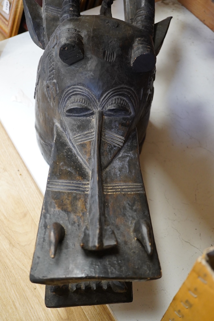African art - a Senufo carved wooden helmet mask (Kponyugo), Ivory Coast, early 20th century, 88cm